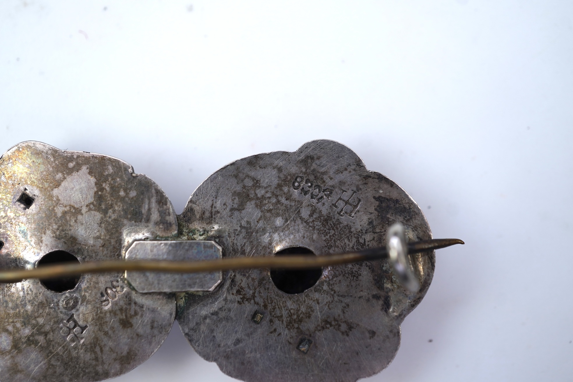 An Arts & Crafts silver slide and three silver brooches, probably Denmark, first half 20th century